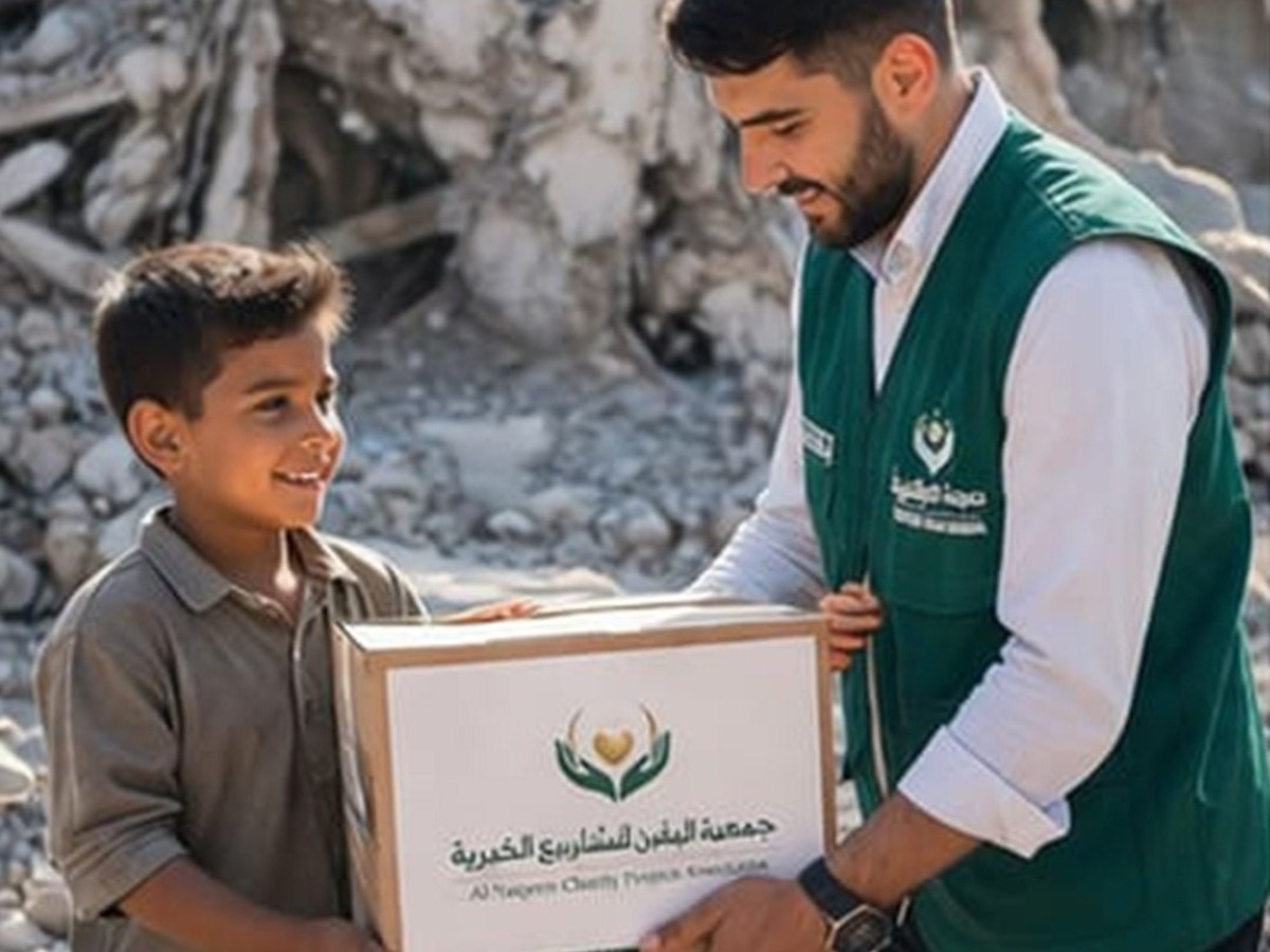 Volunteer delivering a relief box to a child